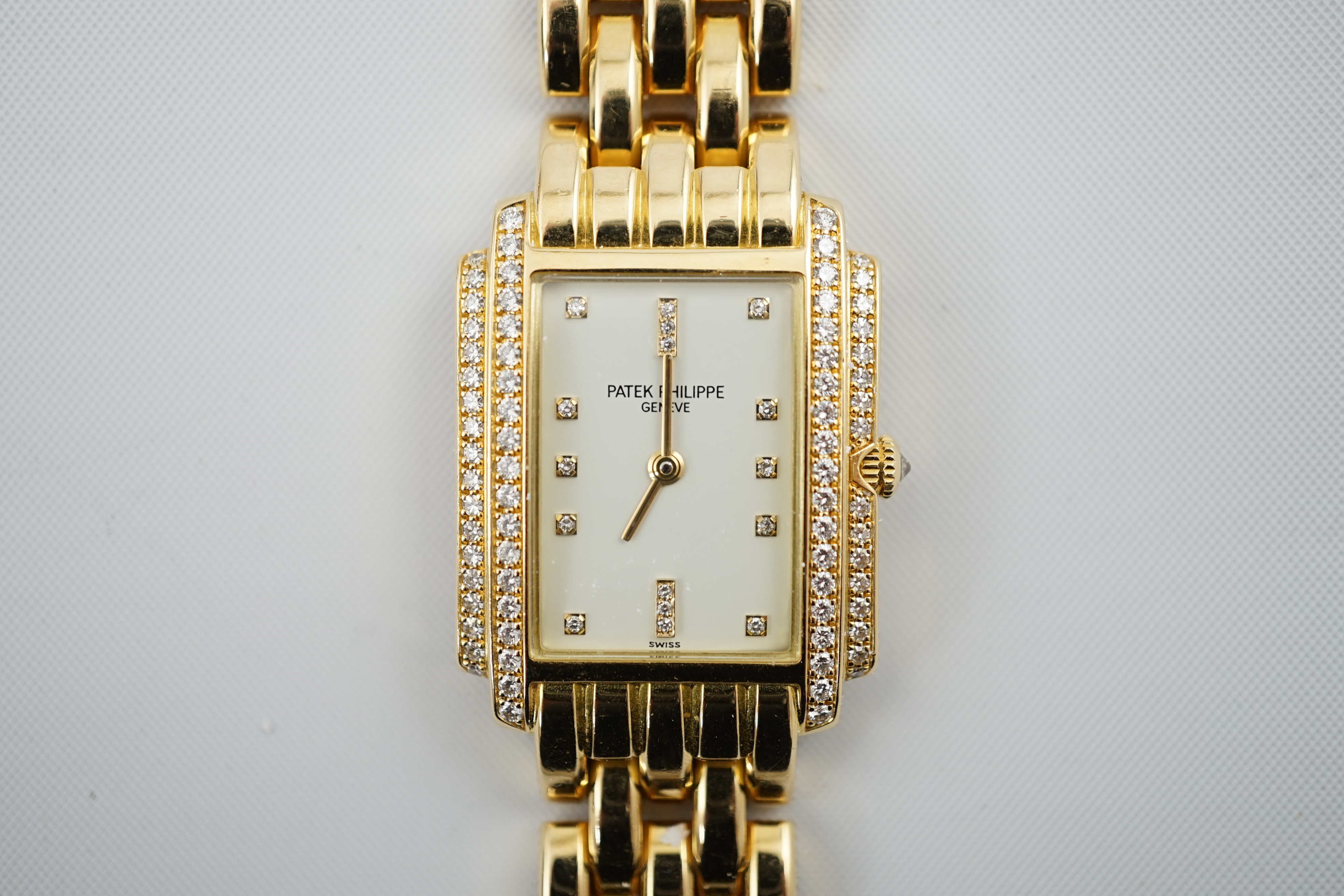 A lady's late 1990's 18ct gold and diamond set Patek Philippe Gondolo quartz wrist watch, on an 18ct gold Patek Philippe bracelet